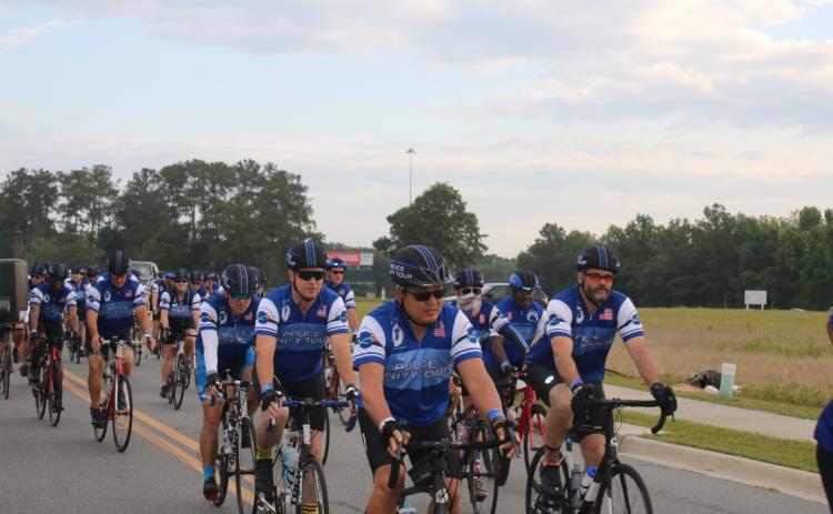 More than 100 police officers and sheriff’s deputies rode through Lake City Monday afternoon to honor fallen police. The bike ride was part of the Police Unity Tour. (TONY BRITT/Lake City Reporter)