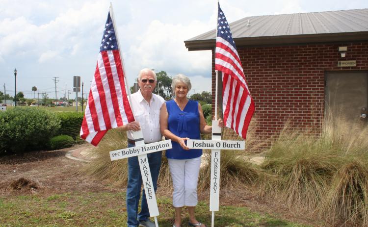 Jack and Ann Hampton stand with a pair of tributes. (TONY BRITT/Lake City Reporter)