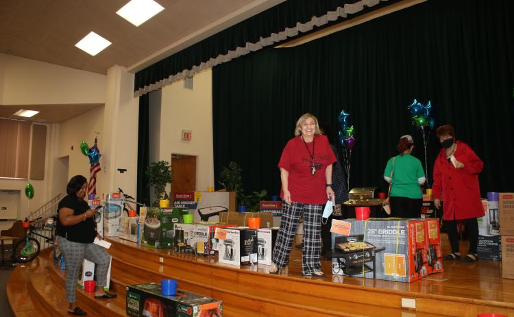 Columbia School District employees look at a variety of items the school district plans to giveaway during the Columbia County Schools Employee Appreciation Extravaganza. (TONY BRITT/Lake City Reporter)