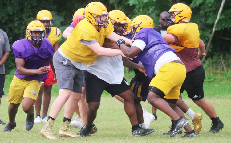 Columbia’s offensive line battles the defensive line during practice last Thursday. Caleb Pope and Travis Matthews are getting their first varsity looks at tackle this spring. (JORDAN KROEGER/Lake City Reporter)