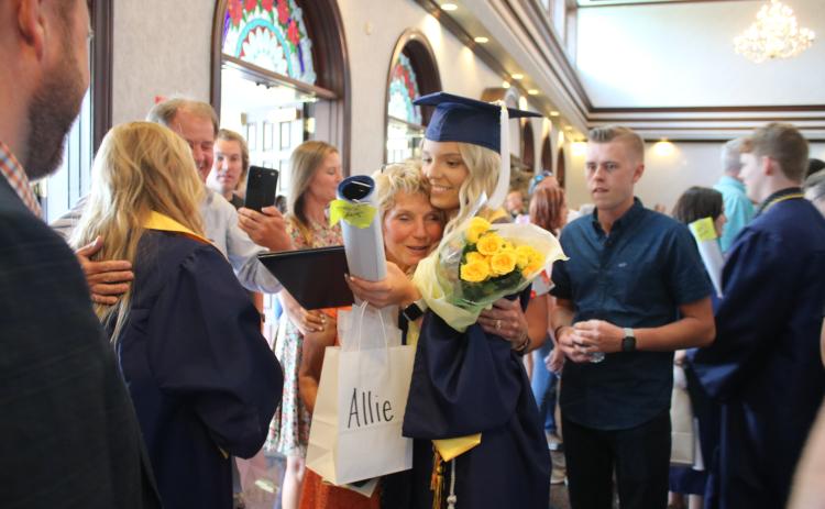 Pam Stuart (left) hugs her granddaughter Alexis Cady, following Belmont’s graduation ceremony. (TONY BRITT/Lake City Reporter)