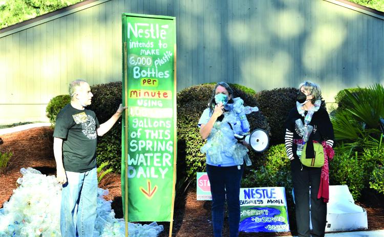 Our Santa Fe River members Michael Roth, from left, Merrillee Malwitz-Jipson and Kristin Rubin protest outside the Suwannee River Water Management District headquarters on the morning of February 23. (FILE)