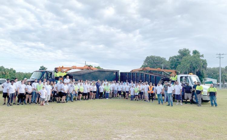 City workers and volunteers pose for a picture before beginning the inaugural county-wide cleanup day work on Saturday morning. Nearly 100 volunteers from Christ Central Ministries participated in the inaugural effort. (COURTESY)