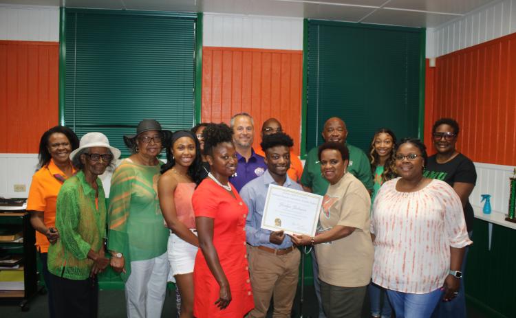 Nicole Newton (front row, from left), Jordyn Johnson, Annie Brooks (Columbia County president of the FAMU Alumni Association) and Trisheka Nelson. (Back row, from left) Pam Miller, Arleen Lofton Poitier, Corrine Lofton, Tonita Orr, Nyla Sams, Trey Hosford, Al Nelson, Mario Coppock, Aniya  Timmons and Evette Watson pose for a photograph during the Jordyn Johnson FAMU scholarship award ceremony. (TONY BRITT/Lake City Reporter)