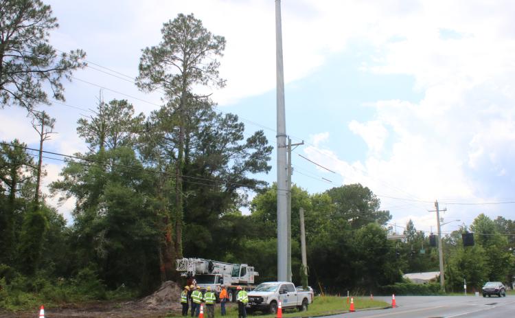 Pike Electric is working on installing newer, taller power lines along Old Country Club Road and County Road 252. (JAMIE WACHTER/Lake City Reporter)