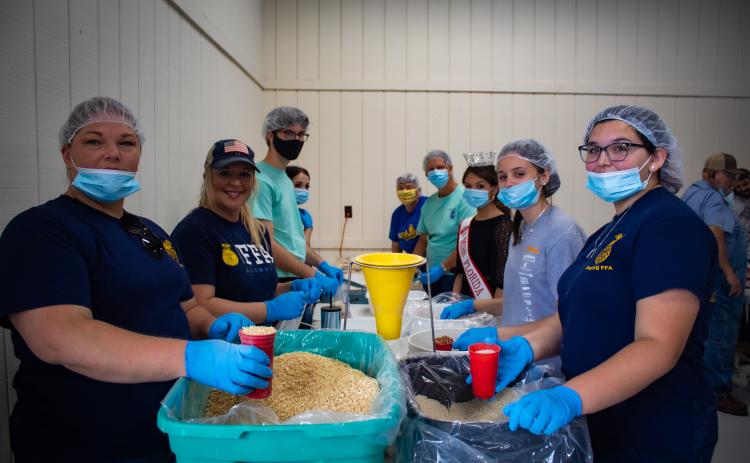 A group of volunteers from Columbia County helps in packaging meals during the recent Meals Of Hope event. (COURTESY)