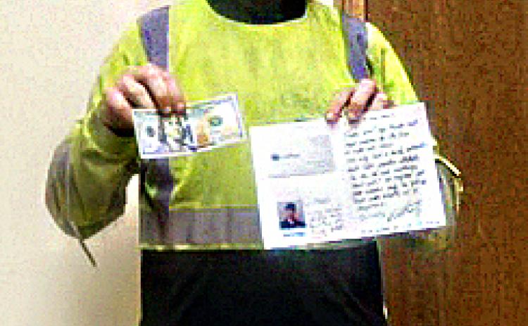 Joel Grecian poses with his $100 and thank-you note from Waste Pro. (COURTESY)
