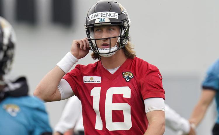 Jacksonville Jaguars quarterback Trevor Lawrence takes a break during practice Monday in Jacksonville. (JOHN RAOUX/Associated Press)