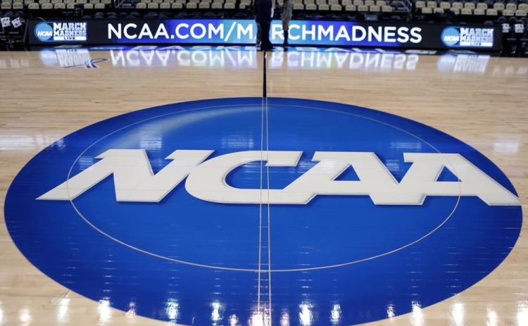 The NCAA logo is displayed as work continues at The Consol Energy Center for the NCAA Tournament on March 15, 2015, in Pittsburgh. The NCAA Board of Directors is expected to greenlight one of the biggest changes in the history of college athletics when it clears the way for athletes to start earning money based on their fame and celebrity without fear of endangering their eligibility or putting their school in jeopardy of violating amateurism rules that have stood for decades. (AP FILE PHOTO)