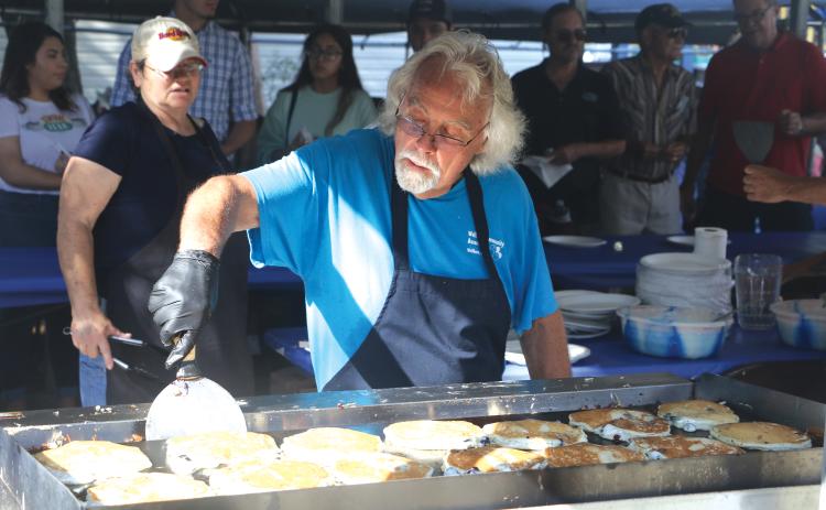 Jim Bezaire flips a batch of blueberry pancakes Saturday morning. (MORGAN MCMULLEN/Lake City Reporter)