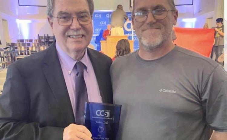 John Cole III (right) poses with his father after John Cole Jr. won the 2021 CCS Teacher of the Year award. (COURTESY)
