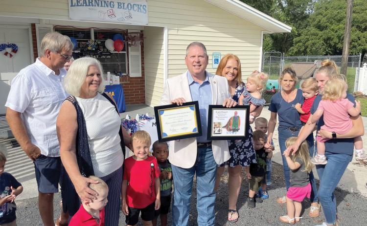 Rep. Chuck Brannan is pictured with parents and their children who benefited from hearing and screening tests June 25 at a Macclenny daycare. (COURTESY)