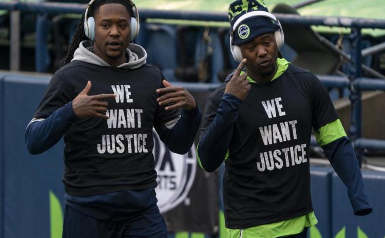 Former Seattle Seahawks cornerback Shaquill Griffin, left, and linebacker Shaquem Griffin are shown during warmups before a game against the Los Angeles Rams on Dec. 27, 2020, in Seattle. The Griffin twins are already talking trash three months before they’re on opposite sidelines for the first time in their lives when the Jacksonville Jaguars host the Miami Dolphins in London this October. (AP FILE)