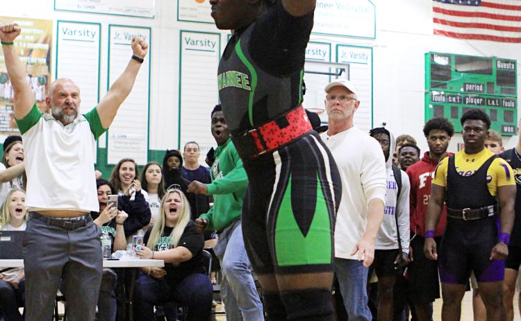 SHS weightlifting coach Dan Marsee (left) raises his fists in celebration after Austin Smith completes a rep. (PAUL BUCHANON/Lake City Reporter)