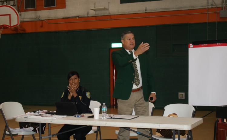 Lake City Police Chief Argatha Gilmore (left) listens while Columbia County Sheriff Mark Hunter addresses the residents Saturday morning at the Community Conversations event at Richardson Community Center. (TONY BRITT/Lake City Reporter)