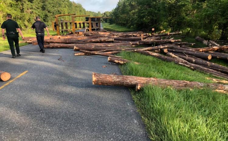 Members of the Suwannee County Fire Rescue and Florida Highway Patrol assess the situation on County Road 137 Friday morning. (COURTESY)