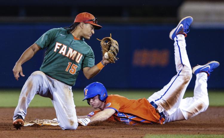 Florida outfielder Brock Edge (18) steals second base, beating the tag by Florida A&M infielder Octavien Moyer (15) during a game on March 4, 2020, in Gainesville. (GARY MCCULLOUGH/Associated Press)