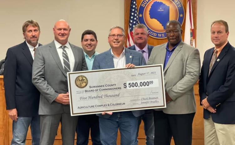 Rep. Chuck Brannan and Hunter Peeler, a legislative aide for Sen. Jennifer Bradley, presented the Suwannee County Board of County Commissioners with a $500,000 state appropriations check Tuesday. Pictured are County Commissioner Travis Land (from left), County Commissioner Don Hale, Peeler, Brannan, County Commissioner Franklin White, County Commissioner Clyde Fleming and County Commissioner Len Stapleton. (COURTESY)