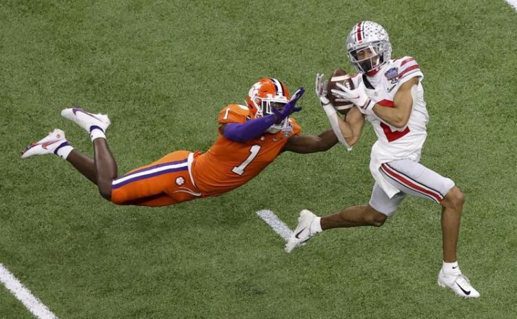 Ohio State wide receiver Chris Olave catches a touchdown pass in front of Clemson cornerback Derion Kendrick during the second half of the Sugar Bowl on Jan. 1 in New Orleans. (AP FILE)