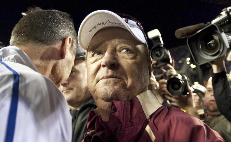 Florida State head football coach Bobby Bowden wears a dejected expression as he turns to leave Florida coach Urban Meyer after congratulating Meyer following Florida's 37-10 win over Florida State on Nov. 28, 2009, in Gainesville. Bowden died Sunday after a battle with pancreatic cancer. (AP FILE)