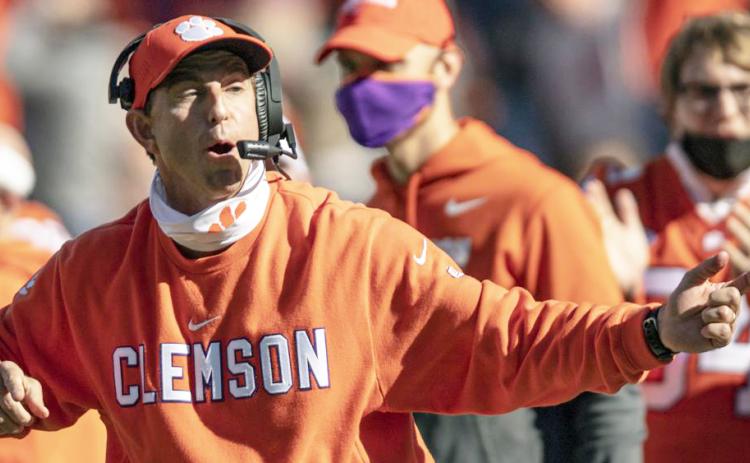 Clemson head coach Dabo Swinney talks with players during the second half of a game against Boston College on Oct. 31, 2020, in Clemson, S.C. Swinney, the coach of No. 3 Clemson faces No. 5 Georgia in the season-opener in Charlotte, N.C. (AP FILE)