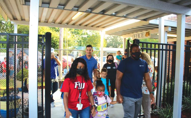 Parents and guardians drop off their children at the first day of school on Aug. 11 at Eastside Elementary. (TONY BRITT/Lake City Reporter)