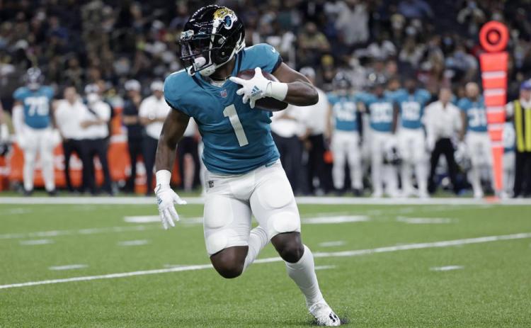 Jacksonville Jaguars running back Travis Etienne (1) carries in the first half of Monday's preseason game in New Orleans. (DERICK HINGLE/Associated Press)