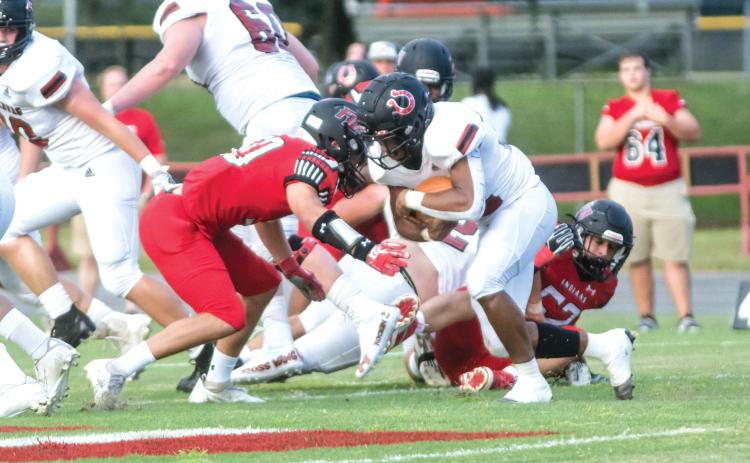 Fort White linebacker Coby Lee (left) makes a tackle on a Middleburg ballcarrier Friday night at Arrowhead Stadium. (CHRISTINA FEAGIN/Lake City Reporter)