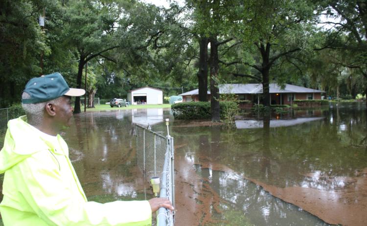 Walter Enman looks over the flooding surrounding his property north of Fort White. (TONY BRITT/Lake City Reporter)