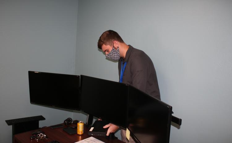 New Lake City IT Director Matt Benedetti works on a desktop setup Wednesday. (TONY BRITT/Lake City Reporter)