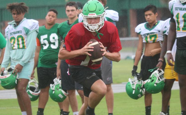 Suwannee quarterback Kodi Lang rolls out to throw during practice on Thursday. (JAMIE WACHTER/Lake City Reporter)