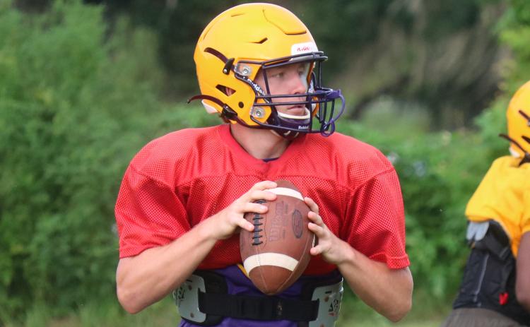 Columbia quarterback Kade Jackson drops back to pass during practice on Aug. 6. (JORDAN KROEGER/Lake City Reporter)