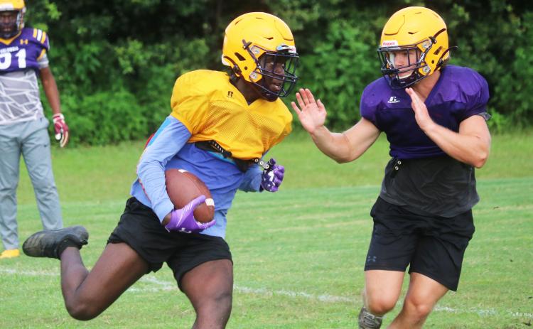 Columbia receiver Brae Deal runs up the field after a catch as linebacker Noah Morris rushes in to tag him during practice on Friday. (JORDAN KROEGER/Lake City Reporter)