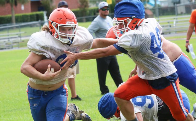 Branford receiver Caden Coker carries the ball up the field during practice on Aug. 13. (JAMIE WACHTER/Lake City Reporter)