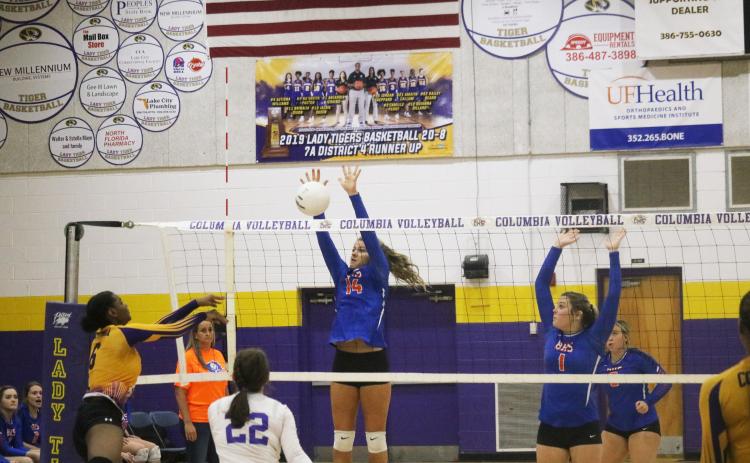 Branford’s Evie Pitts rises to block a shot from Columbia’s Zimora Owens during a match last season. (JORDAN KROEGER/Lake City Reporter)