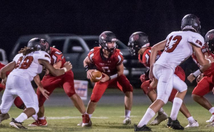 Fort White quarterback Clayton Philpot turns to hand the ball off against Middleburg during the teams’ Preseason Classic on Aug. 20. (CHRISTINA FEAGIN/Special to the Reporter)