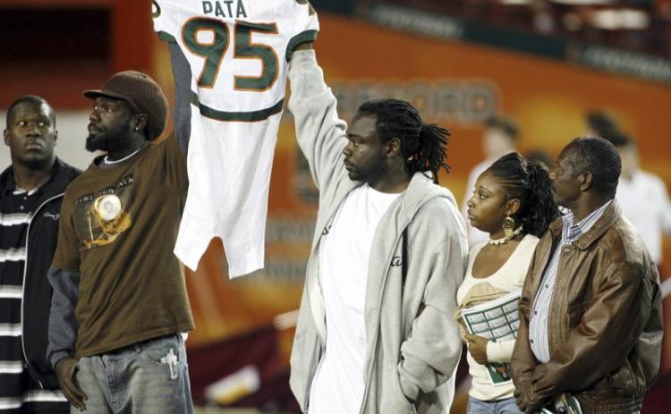 Bryan Pata's family hold up his jersey at the beginning of a game between Miami and Boston College at the Orange Bowl on Nov. 23, 2006, in Miami. Rashaun Jones, 35, of Lake City, a former University of Miami football player was arrested Thursday in connection with the 2006 fatal shooting of his teammate Bryan Pata. Pata, a 22-year-old, 6-foot-4, 280-pound defensive lineman, was shot several times outside of his Kendall apartment the night of Nov. 7, 2006. (AP FILE PHOTO)