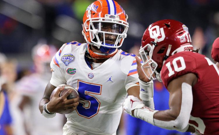 Florida quarterback Emory Jones (5) fends off Oklahoma safety Pat Fields (10) during last year's Cotton Bowl on Dec. 30, 2020, in Arlington, Texas. (RONALD MARTINEZ/Getty Images/TNS)
