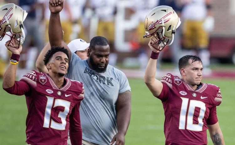 Florida State quarterbacks Jordan Travis (13) and McKenzie Milton (10), and defensive tackle Robert Cooper (91) walk off the field before their game against Notre Dame at Doak Campbell Stadium on Sept. 5 in Tallahassee. (WILLIE J. ALLEN/Orlando Sentinel/TNS) Jr.