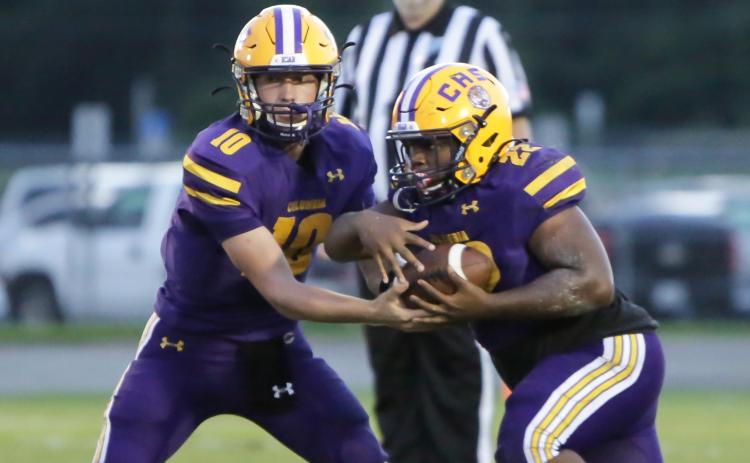 Columbia quarterback Kade Jackson hands the ball off to running back Tony Fulton against Bolles on Sept. 3. (BRENT KUYKENDALL/Lake City Reporter)