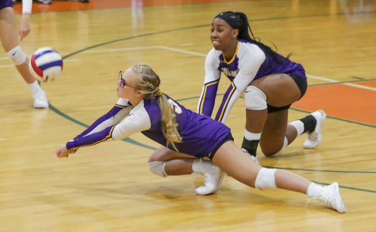 Columbia's Bailey Campbell (left) and Brandi Oliver (right) dive for a ball against P.K. Yonge on Tuesday night. (BRENT KUYKENDALL/Lake City Reporter)