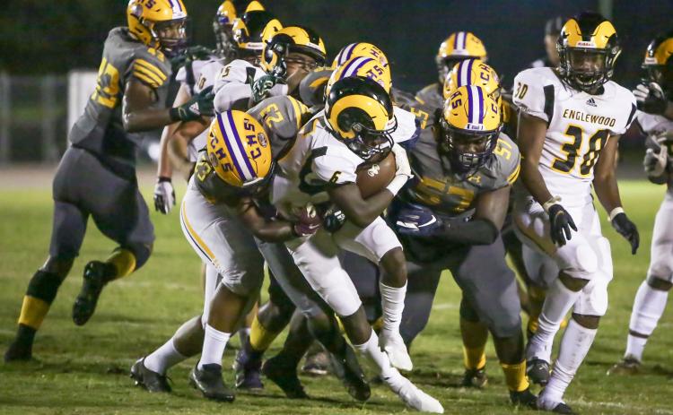 Columbia linebacker Tyrell Peterson (23) and defensive tackle Jihycein Weston (57) tackle Englewood running back Tayshaun Solomon on Friday night. (BRENT KUYKENDALL/Lake City Reporter)