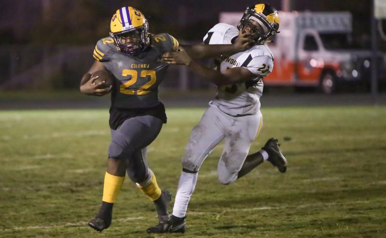 Columbia running back Tony Fulton tries to fight off  a tackle by Englewood linebacker Keeric Merrell on Friday night. (BRENT KUYKENDALL/Lake City Reporter)