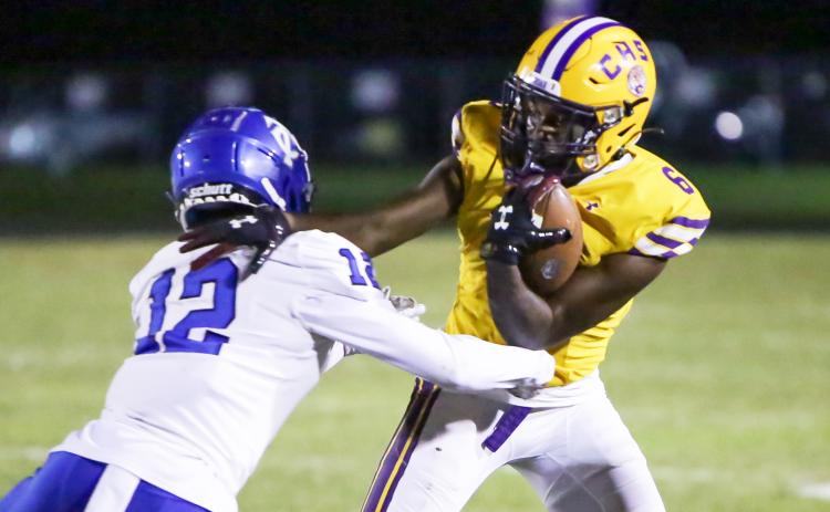 Columbia receiver Tray Tolliver tries to escape a tackle from Trinity Christian defensive back Tyler Jackson on Friday night. (BRENT KUYKENDALL/Lake City Reporter)