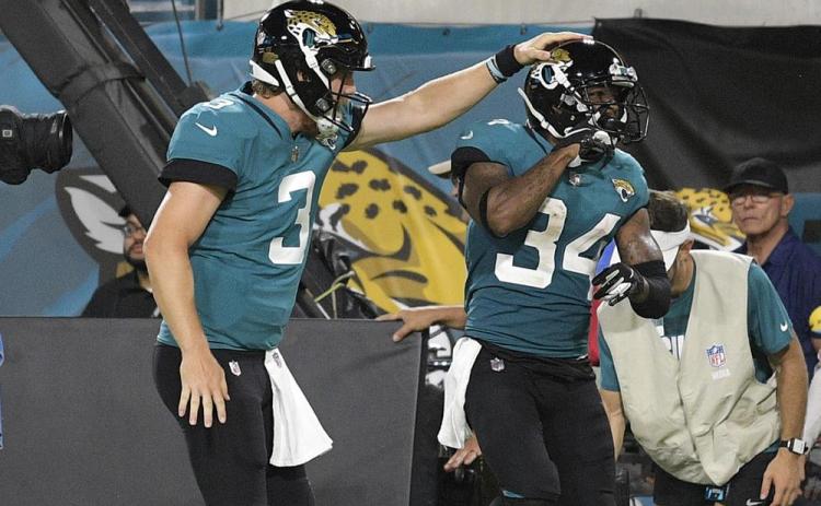 Jacksonville Jaguars quarterback C.J. Beathard (3) congratulates wide receiver Tavon Austin (34) after a reception for a touchdown against the Cleveland Browns during a NFL preseason football game on Aug. 14 in Jacksonville. (PHELAN M. EBENHACK)