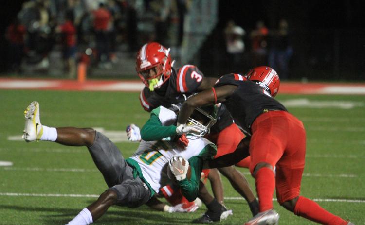 Suwannee receiver/running back Terrell Atkinson gets tackled by Bradford on Friday night. (PAUL BUCHANAN/Special to the Reporter)