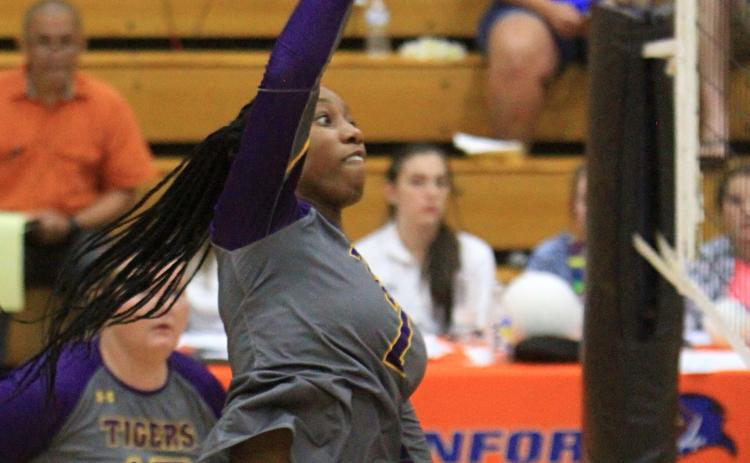 Columbia hitter Brandi Oliver sends a shot over the net against Branford on Wednesday night. (PAUL BUCHANAN/Special to the Reporter)