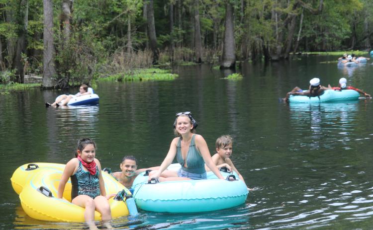 Rain (from left), Ivan, Nicolette and Theodore Sacino float down the Ichetucknee on their tubes Monday afternoon while celebrating Labor Day. (TONY BRITT/Lake City Reporter)