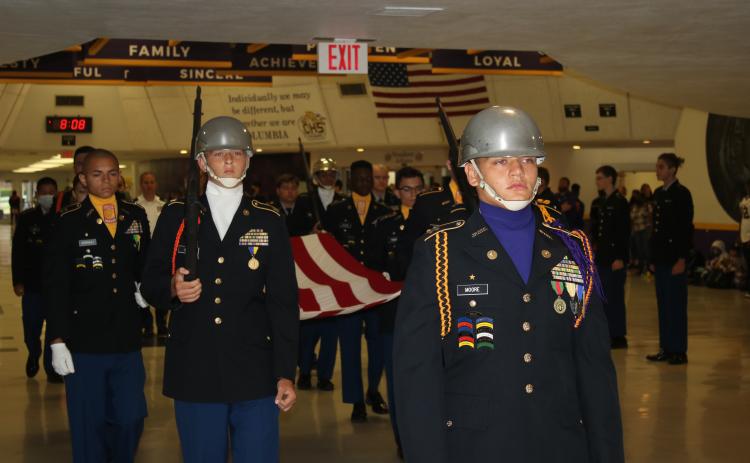 Ethan Moore (center), CHS Battalion commander for the Tiger Battalion, leads JROTC cadets through students and staff followed by Noah Smith (left) and other cadets Friday morning during the JROTC’s annual memorial march in honor of 9/11 victims. (TONY BRITT/Lake City Reporter)