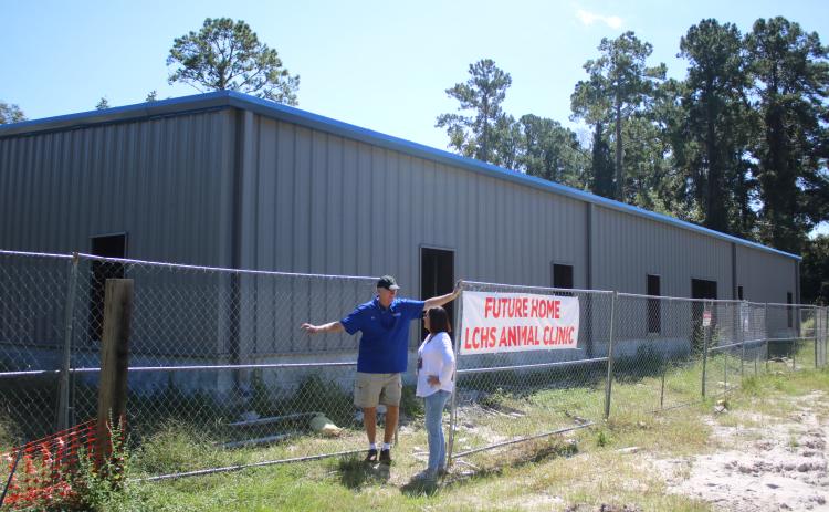 Keith Williams (left), Lake City-Columbia County Humane Society board of directors president talks to Robin Tobak Ward, LCHS executive director, Friday morning while aiding with the construction of the James Montgomery Animal Wellness Center. Officials hope to open the facility in December. (TONY BRITT/Lake City Reporter)